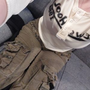 Green cargo pants and a white crop tee